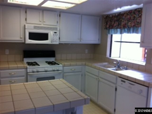 5870 Coyote Ridge Road Reno, NV 89523 - Photo 3 of 6 a kitchen with a sink a stove and cabinets