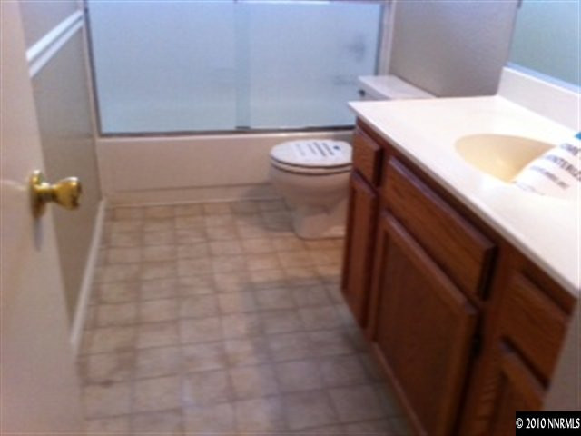5870 Coyote Ridge Road Reno, NV 89523 - Photo 6 of 6 a bathroom with a sink a toilet and shower