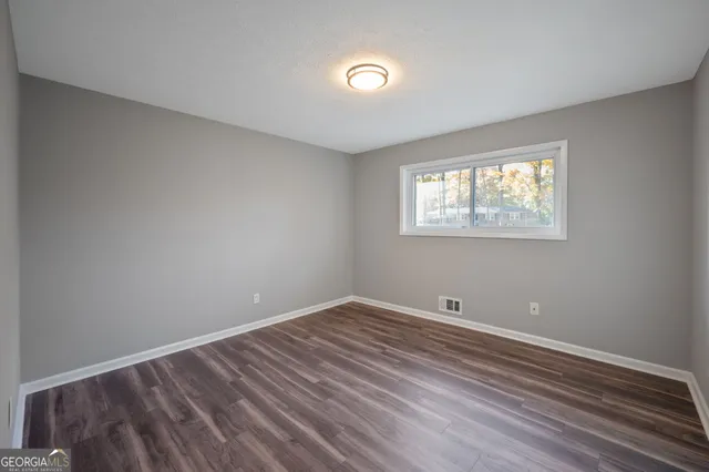 a view of room with hardwood floor and window