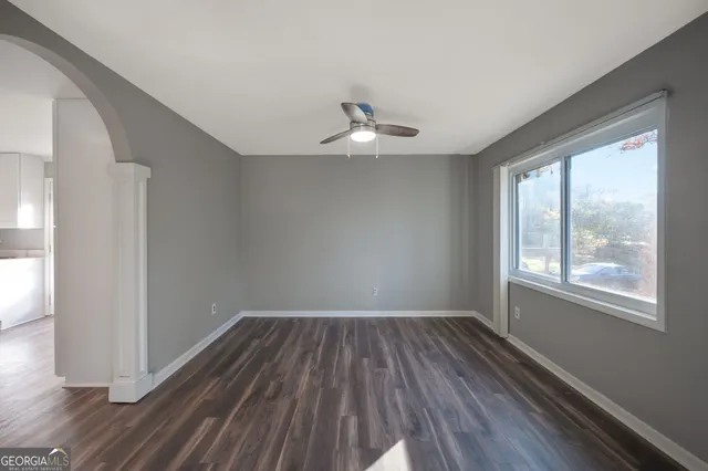 wooden floor in an empty room with a window