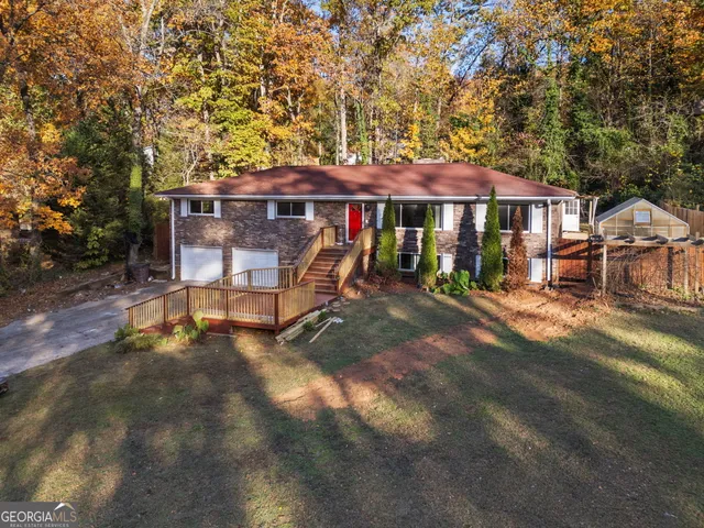 a view of a house with backyard porch and sitting area