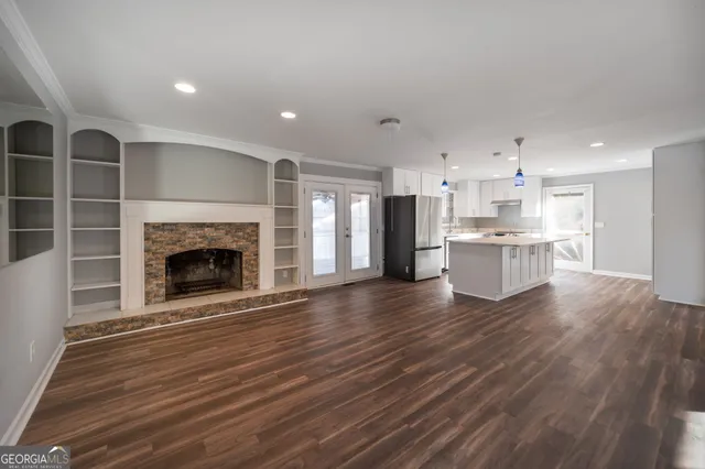 a view of a kitchen with a sink a refrigerator and a fireplace