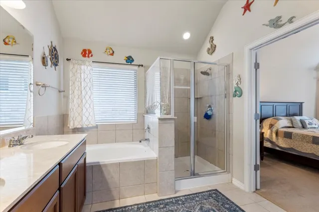 a en suite bathroom with a tub shower and sink