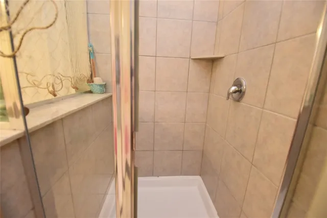 a bathroom with a bathtub and shower