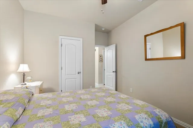 a bedroom with a bed and a lamp