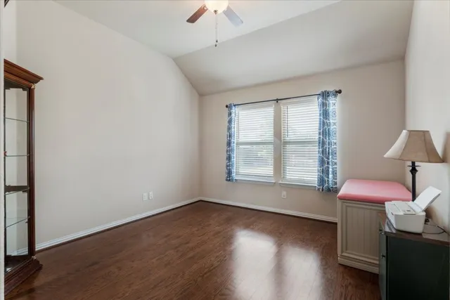 a livingroom with window and hardwood floor