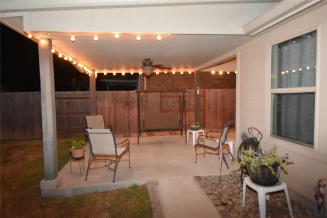 a building outdoor space with patio furniture and potted plants