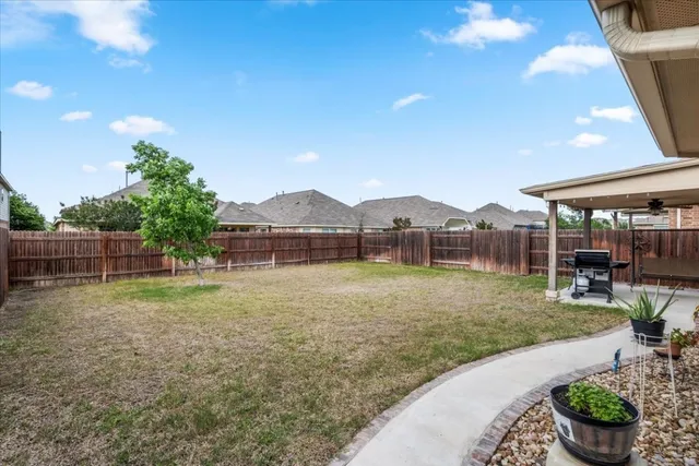 a view of a house with backyard and sitting area