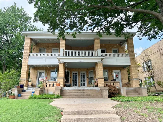 a front view of a house with garden and patio
