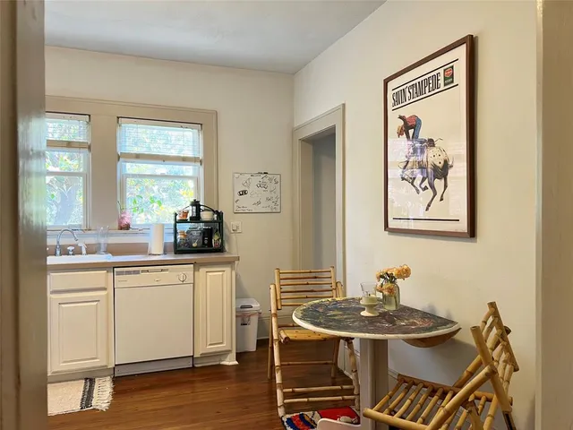 a living room with stainless steel appliances kitchen island granite countertop furniture and wooden floor