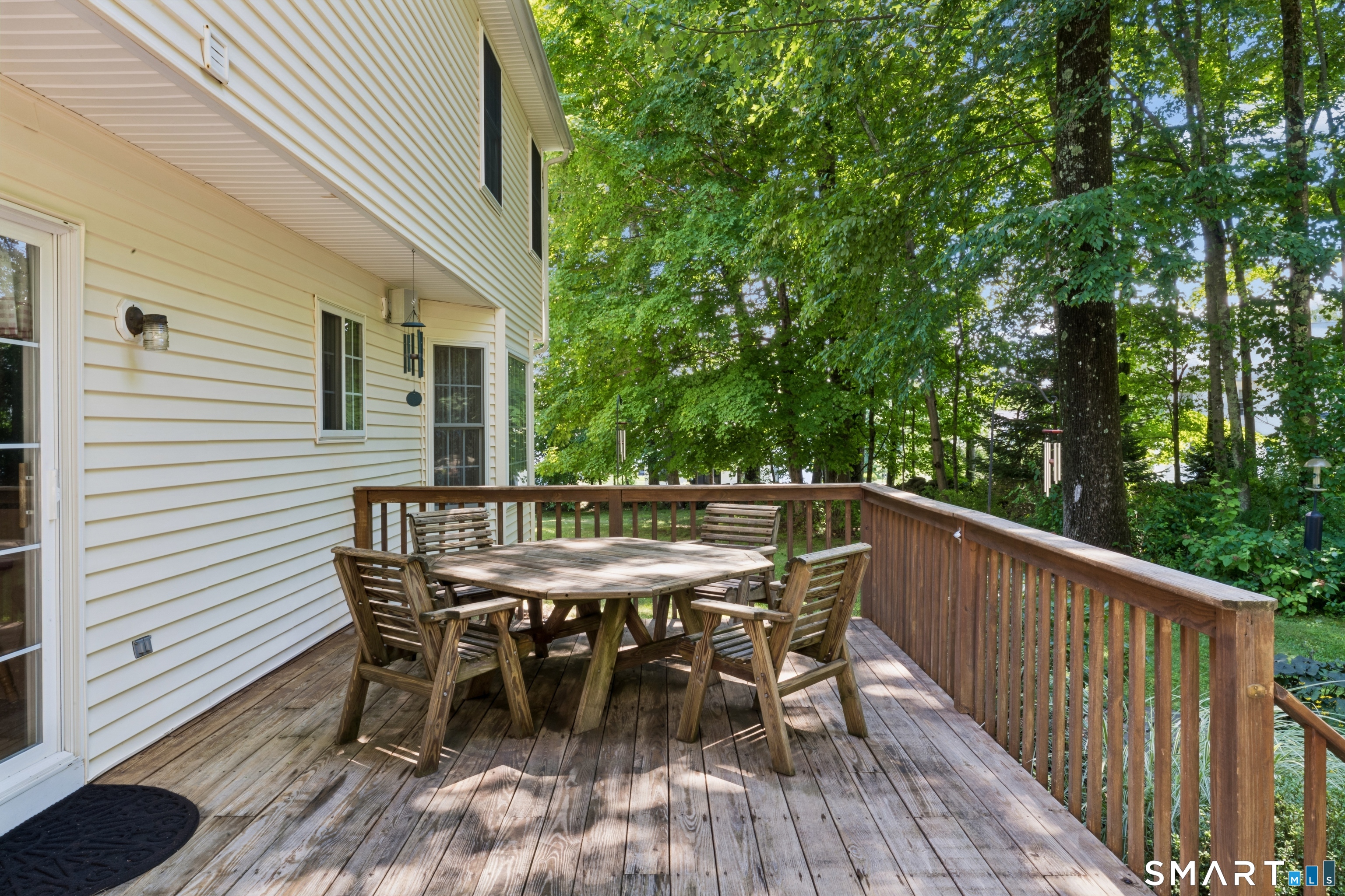 10 Ferris Road Newtown, CT 06470 - Photo 36 of 40 a view of a roof deck with table and chairs and wooden floor