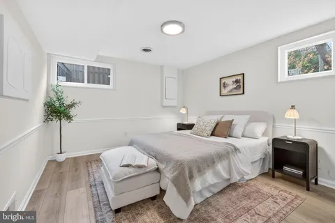 a bedroom with a bed and a potted plant