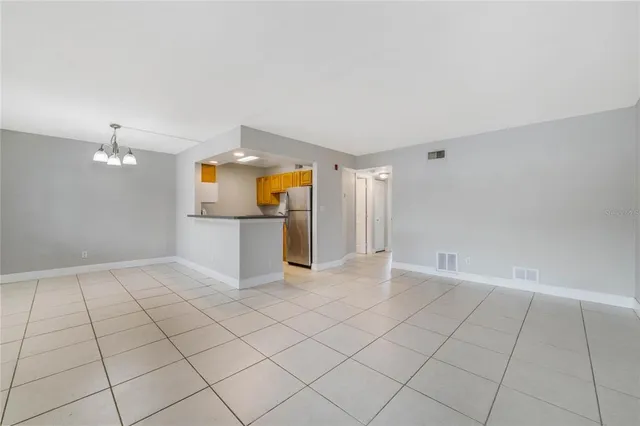 an empty room with fireplace and windows