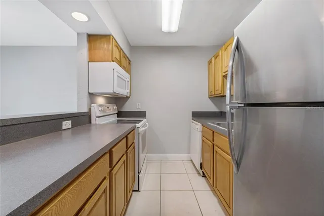 a kitchen with stainless steel appliances a sink stove and cabinets