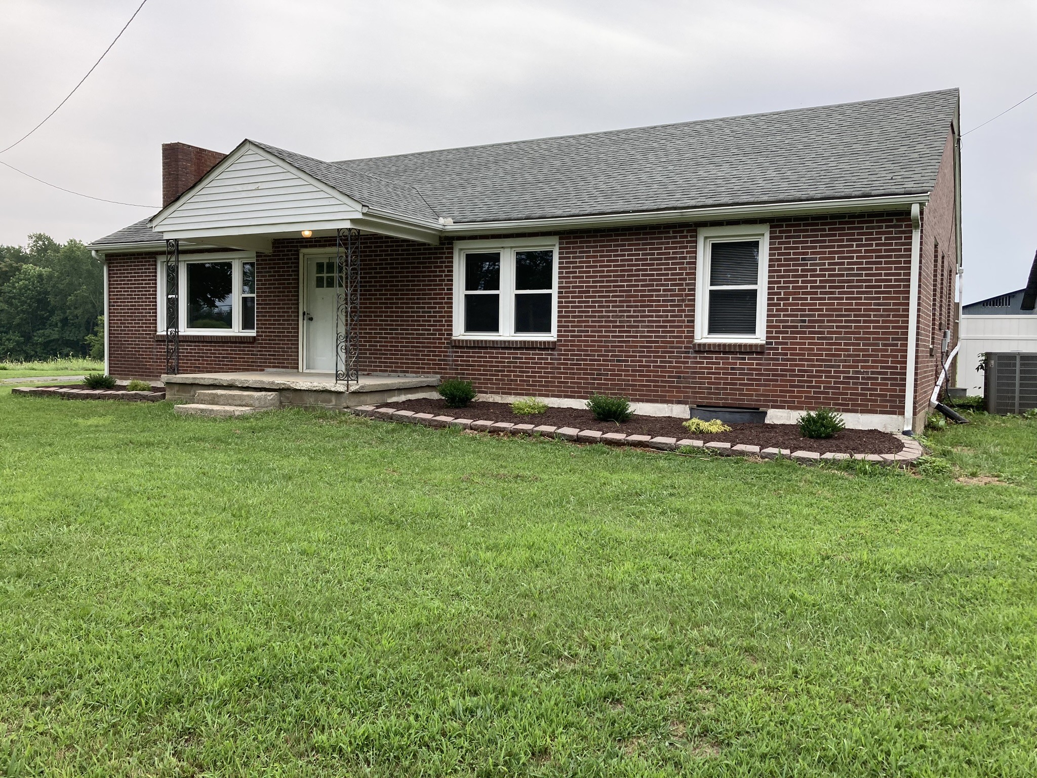2220 Willette Road Red Boiling Springs, TN 37150 - Photo 1 of 30 a front view of a house with a garden