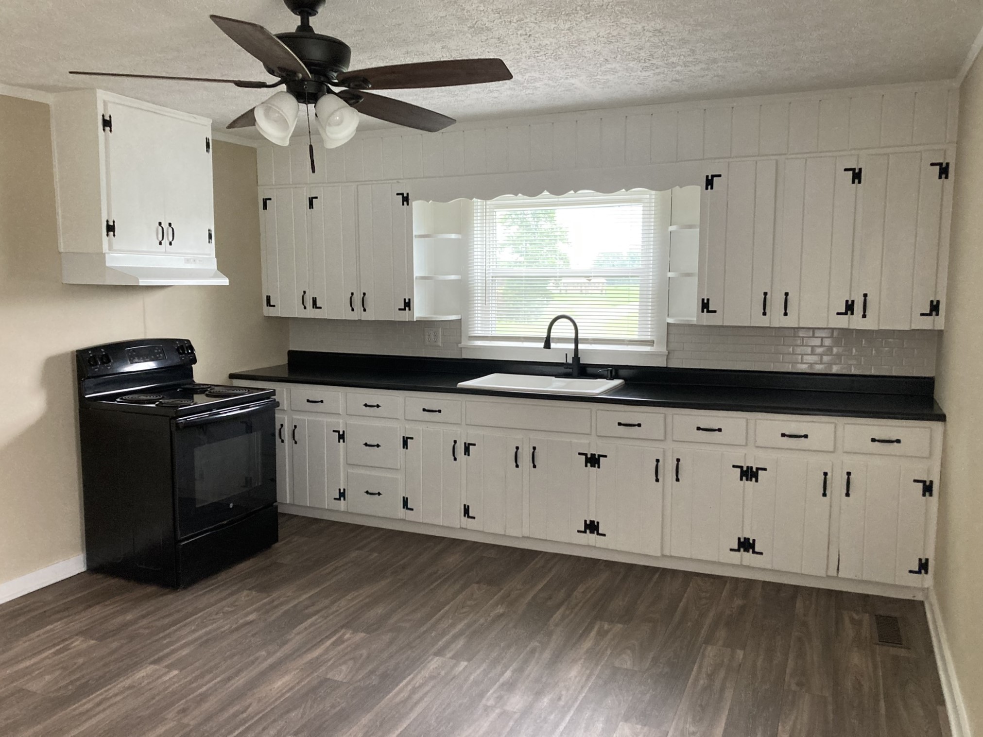 2220 Willette Road Red Boiling Springs, TN 37150 - Photo 12 of 30 a kitchen with granite countertop white cabinets white stainless steel appliances with wooden floor