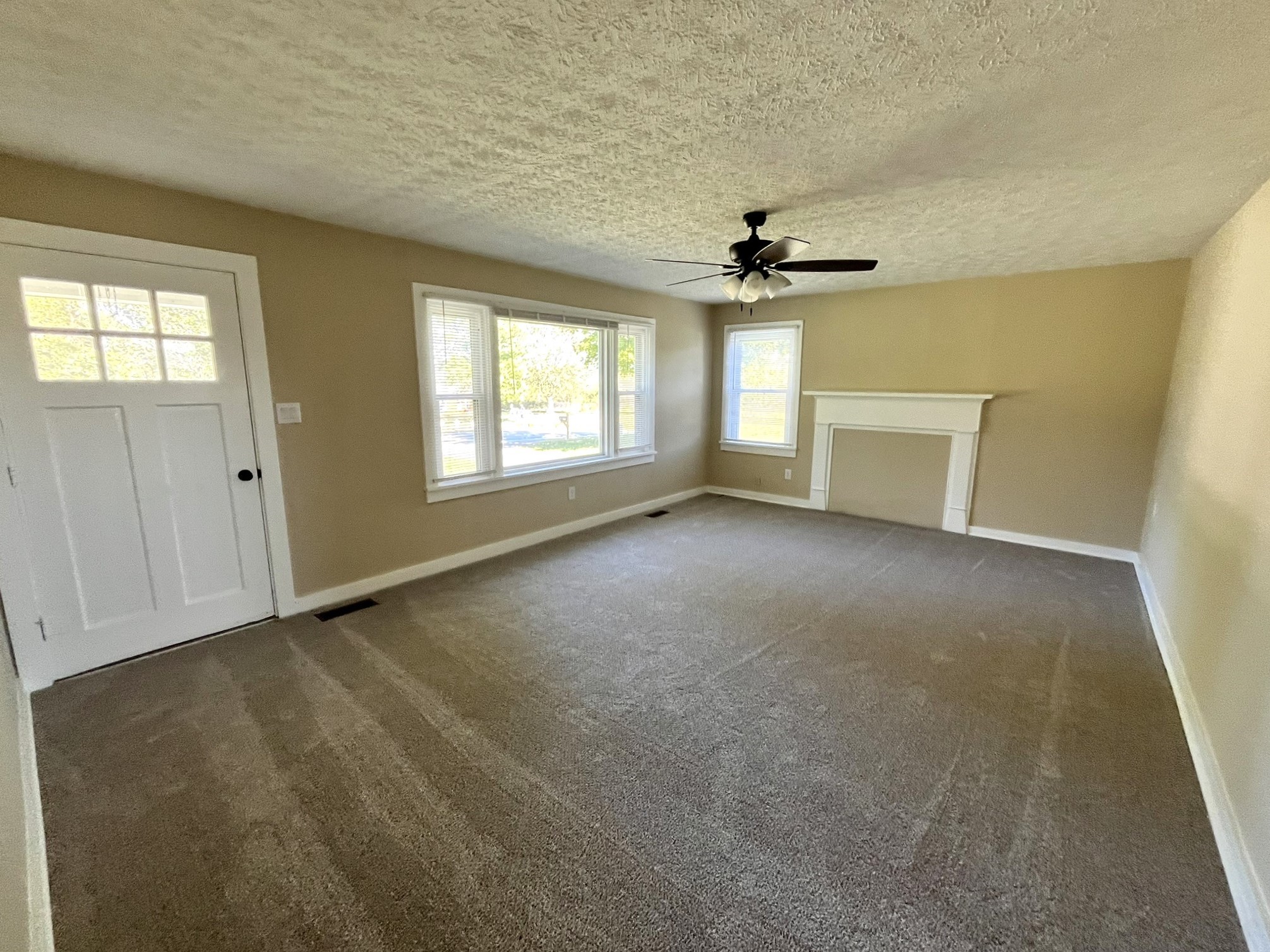 2220 Willette Road Red Boiling Springs, TN 37150 - Photo 10 of 30 an empty room with windows and chandelier fan