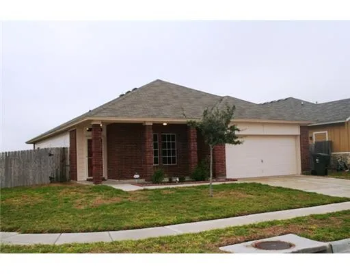 a front view of a house with a garden and yard