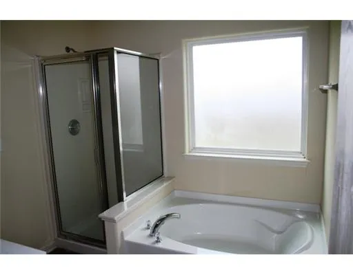 a bathroom with a tub and a sink