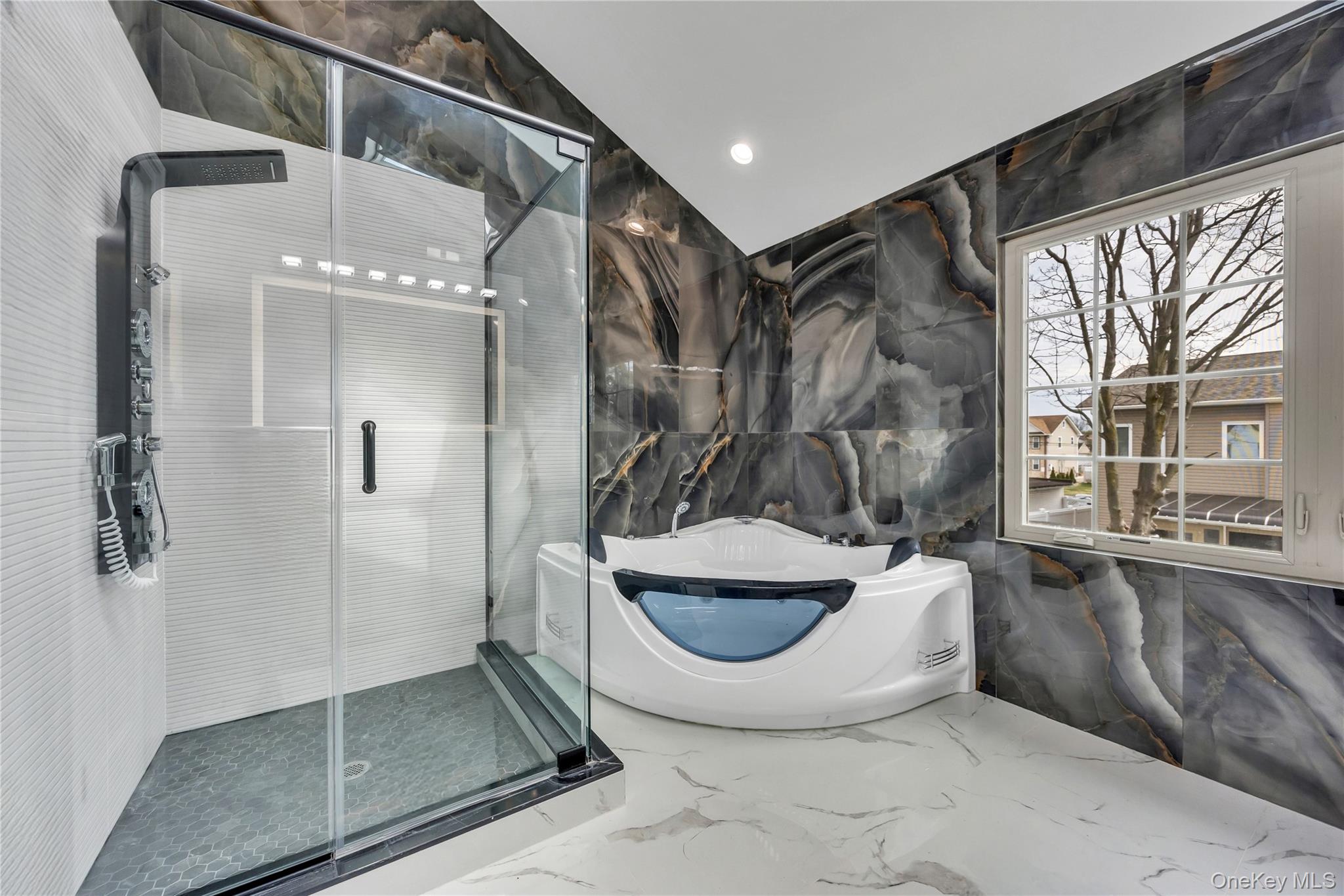 157 4th Street Hicksville, NY 11801 - Photo 11 of 20 Full bathroom with a shower stall, marble finish floor, a freestanding tub, and stone wall