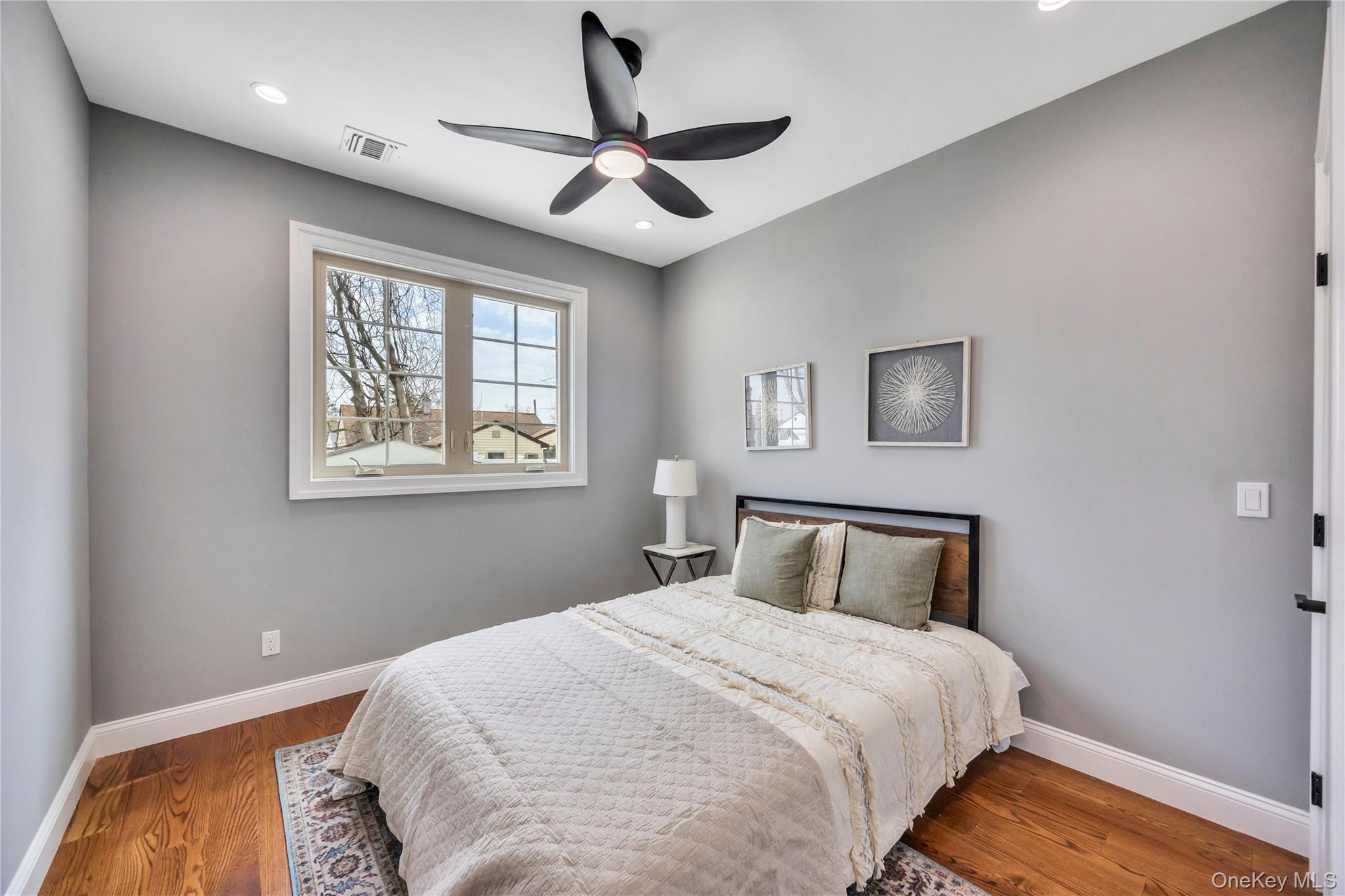 157 4th Street Hicksville, NY 11801 - Photo 12 of 20 Bedroom with baseboards, wood finished floors, visible vents, and recessed lighting