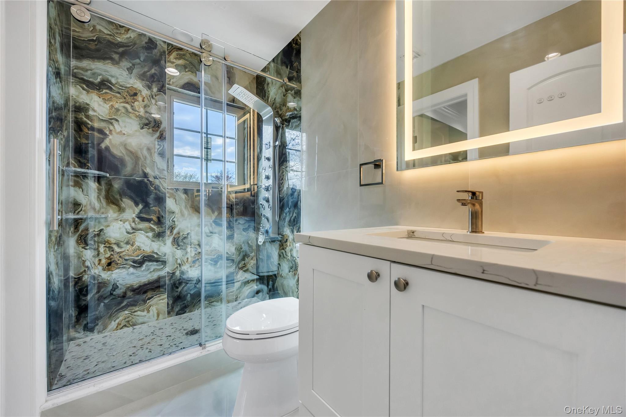 157 4th Street Hicksville, NY 11801 - Photo 13 of 20 Bathroom featuring toilet, vanity, and a marble finish shower