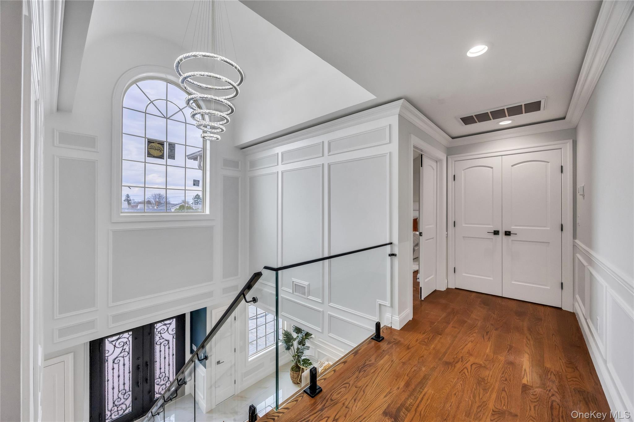 157 4th Street Hicksville, NY 11801 - Photo 16 of 20 Hall with visible vents, an inviting chandelier, a healthy amount of sunlight, and a decorative wall