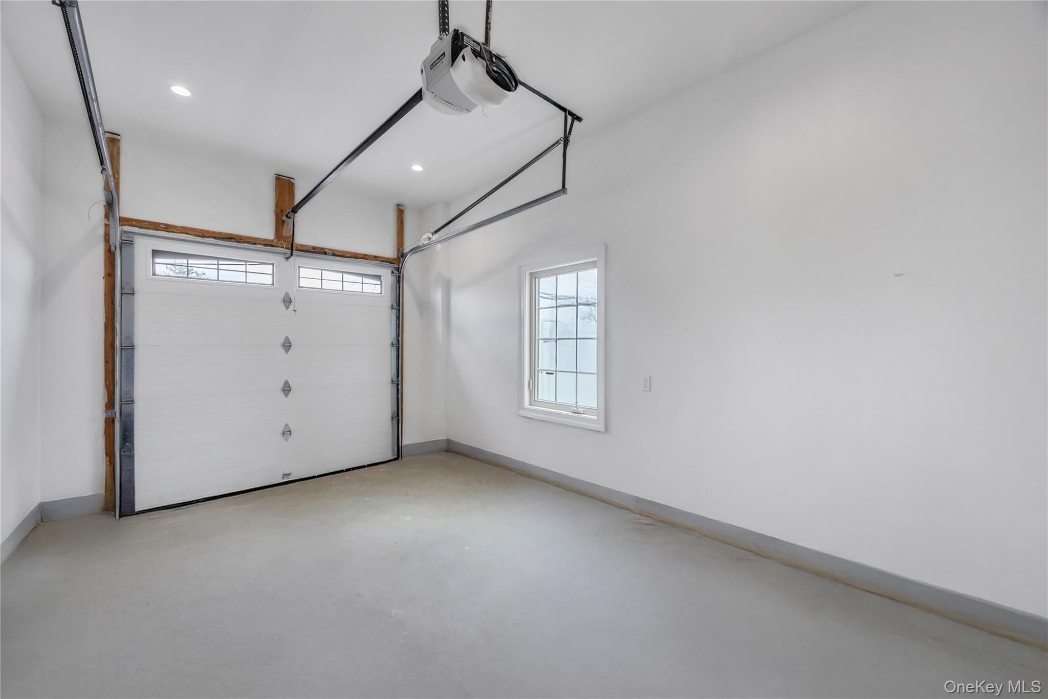 157 4th Street Hicksville, NY 11801 - Photo 17 of 20 Garage with baseboards, recessed lighting, and a garage door opener