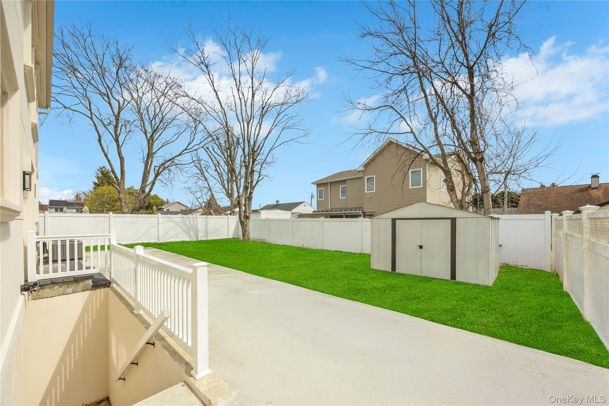 157 4th Street Hicksville, NY 11801 - Photo 18 of 20 View of patio featuring a fenced backyard, an outdoor structure, and a storage shed