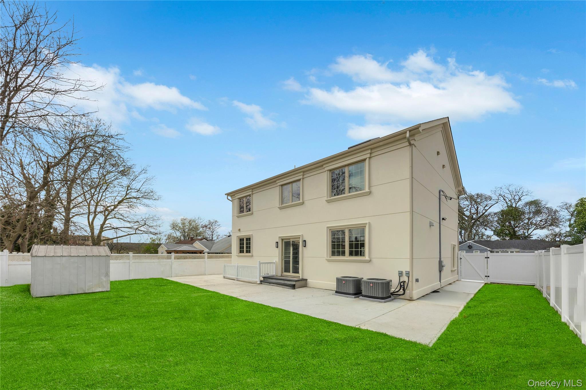 157 4th Street Hicksville, NY 11801 - Photo 19 of 20 Rear view of property featuring a storage unit, a patio area, a lawn, and a fenced backyard