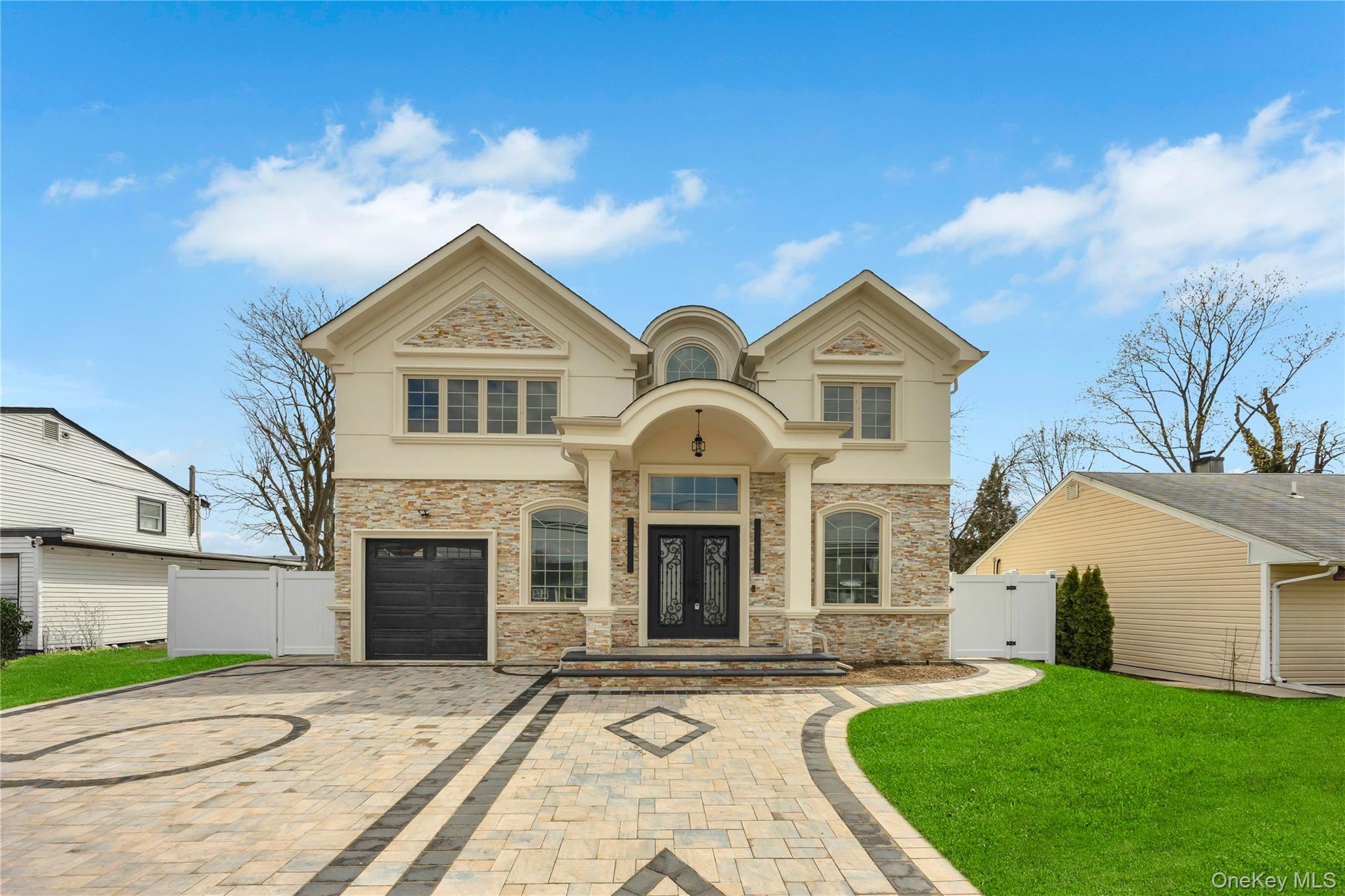 157 4th Street Hicksville, NY 11801 - Photo 20 of 20 View of front facade featuring a gate, stone siding, decorative driveway, and fence