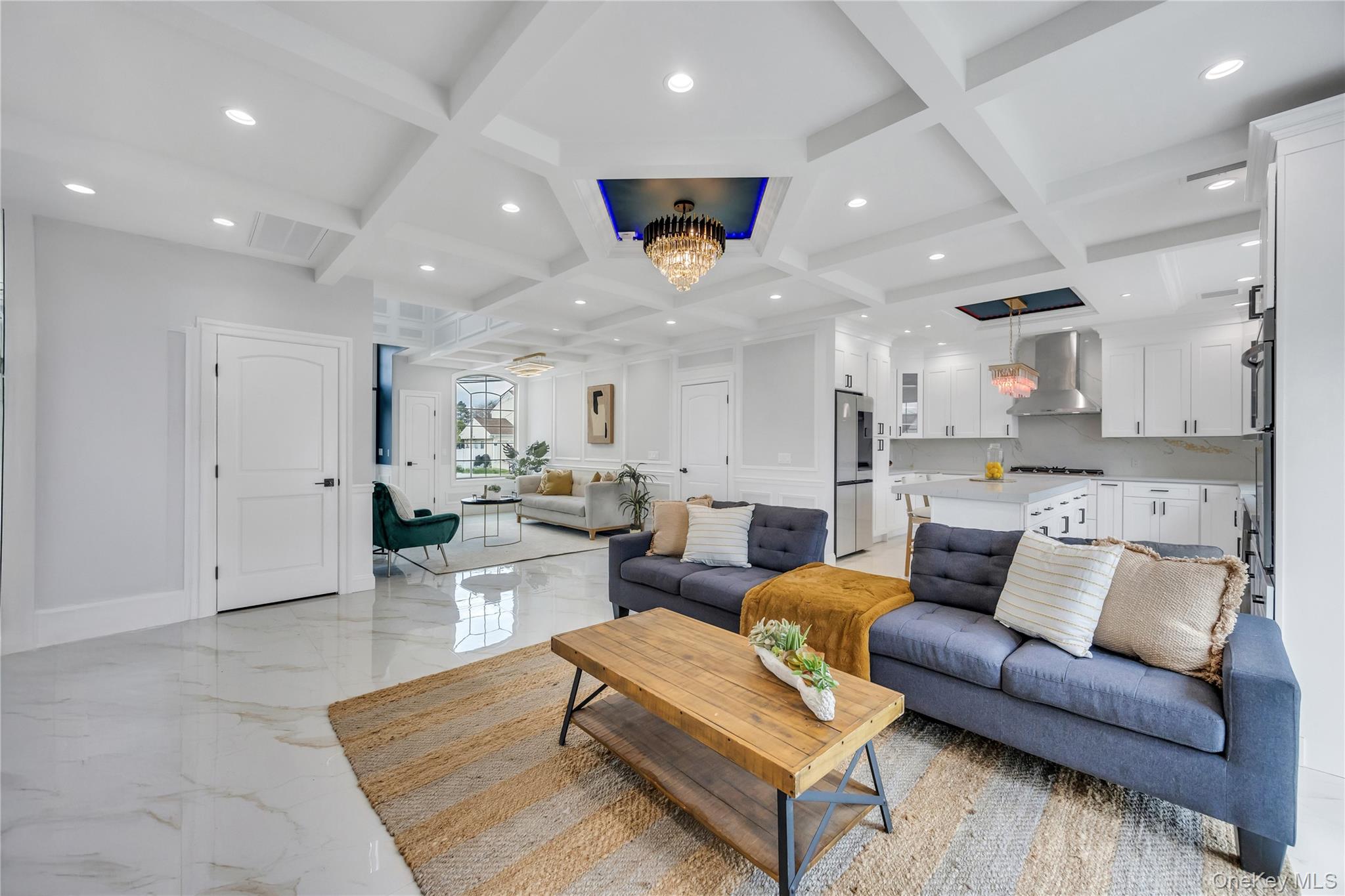 157 4th Street Hicksville, NY 11801 - Photo 5 of 20 Living room with beamed ceiling, an inviting chandelier, marble finish floor, and coffered ceiling