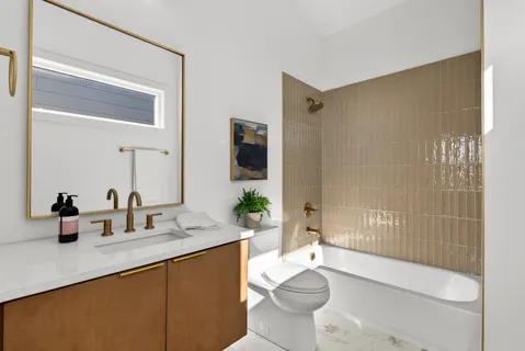 a bathroom with a double vanity sink toilet and shower