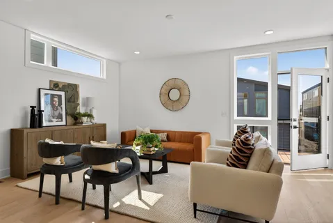 a living room with furniture and a lamp