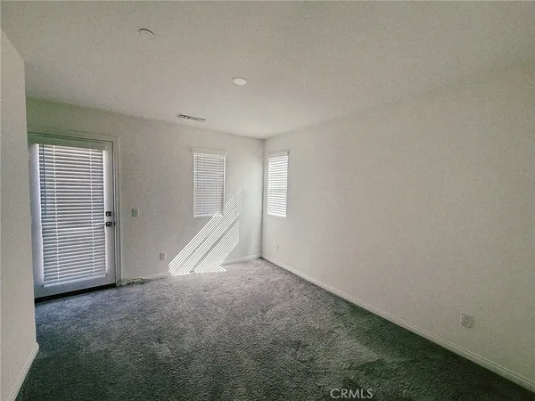 a view of an empty room with a bathroom