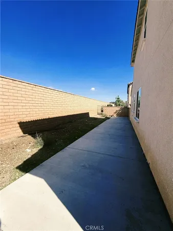 a roof deck with couch and chairs