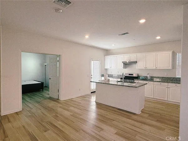 a kitchen with stainless steel appliances granite countertop a sink and cabinets