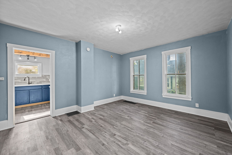 1419 17th Street Moline, IL 61265 - Photo 13 of 28 a view of an empty room with a window and wooden floor