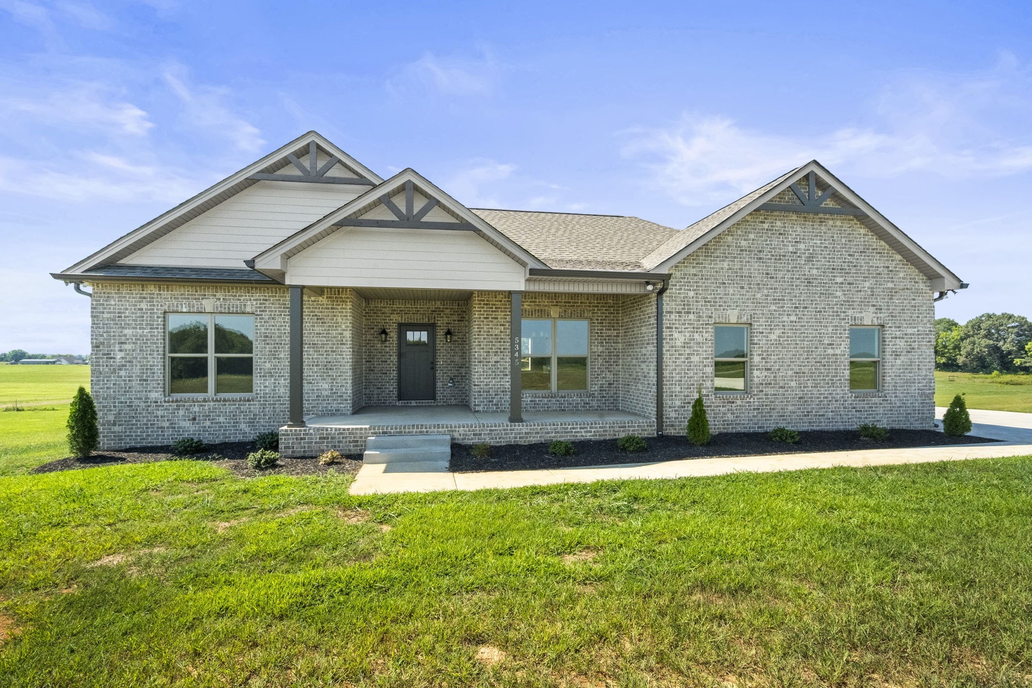 a front view of a house with a yard and outdoor seating