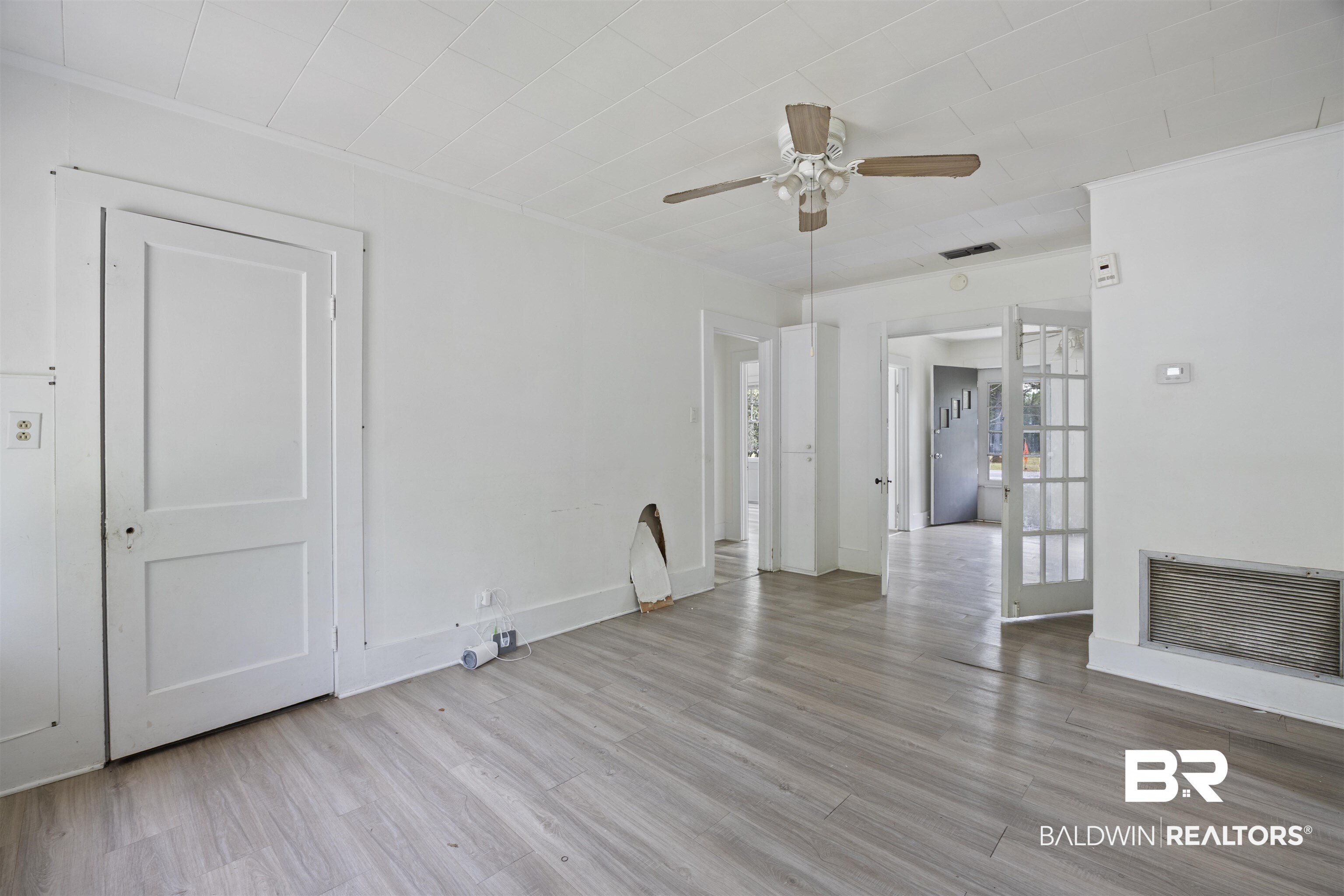 112 South Juniper Street Foley, AL 36535 - Photo 40 of 64 Unfurnished living room featuring a ceiling fan, light wood-style floors, and crown molding