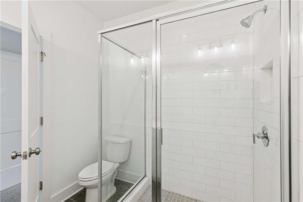 140 Color Circle Atlanta, GA 30317 - Photo 14 of 22 a bathroom with a glass shower door