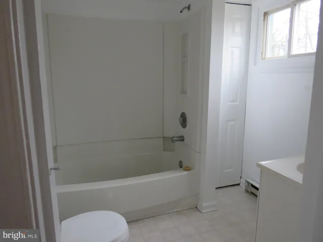 a bathroom with a bathtub and a toilet
