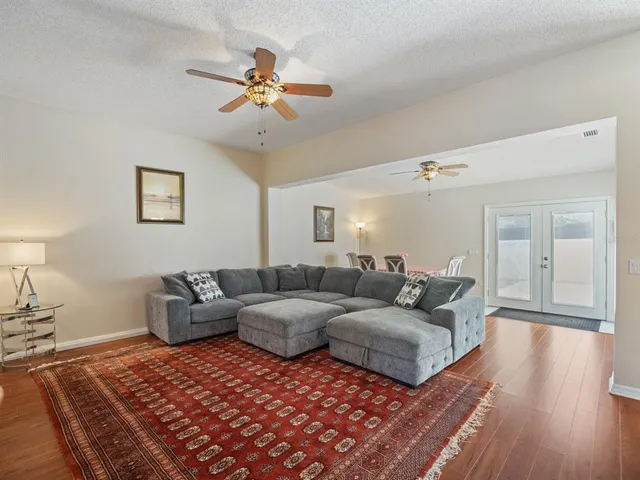 a living room with furniture and a wooden floor