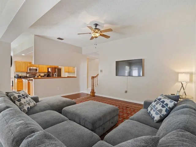 a living room with furniture and a ceiling fan