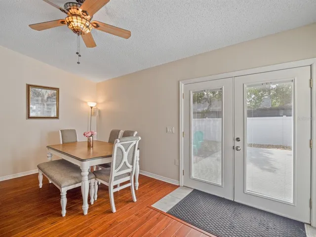 a view of a dining room with furniture wooden floor and chandelier
