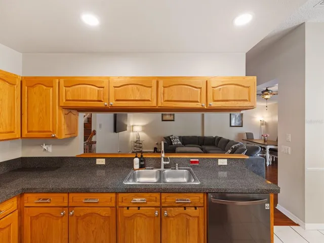 a kitchen with stainless steel appliances granite countertop a sink and cabinets