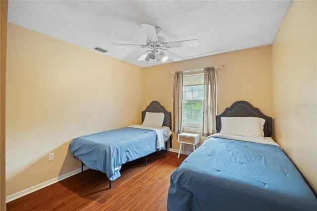 a bedroom with two beds and a chandelier