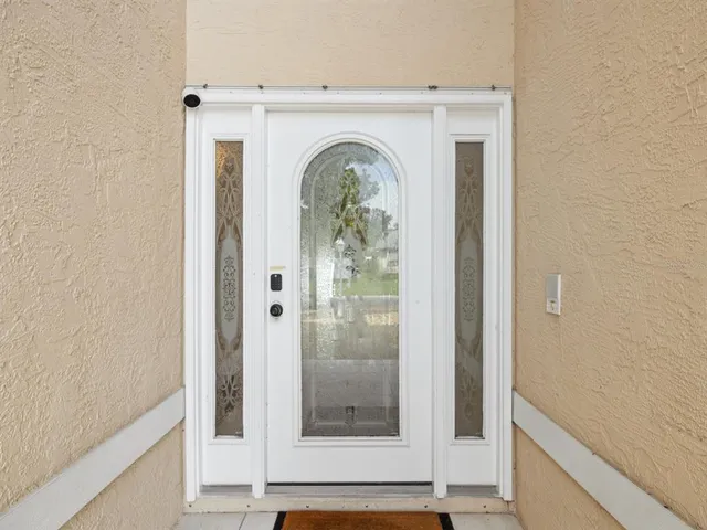 a view of a entryway door with wooden floor