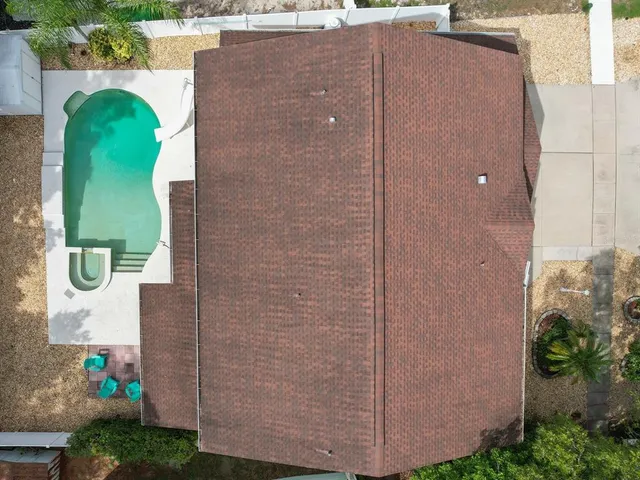 an aerial view of residential houses with city view