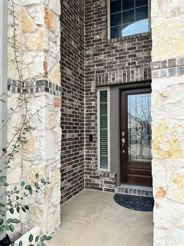 a brick building with a door and a window